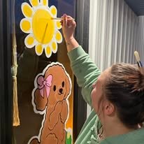 Hand-painted seasonal window art by Banner Barn