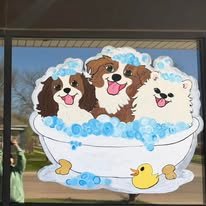Hand-painted seasonal window art by Banner Barn